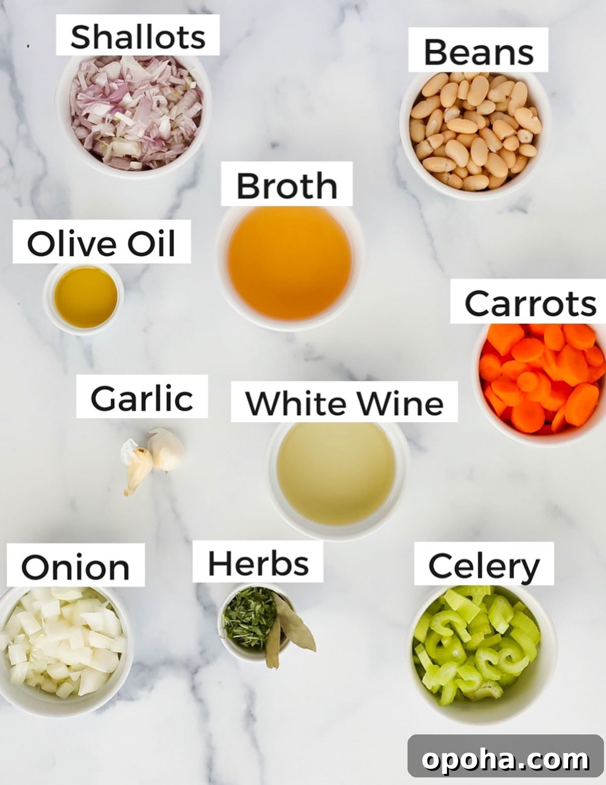 Labeled ingredients in small white bowls including: shallots, beans, olive oil, broth, carrots, garlic, white win, onion, herbs, and celery.