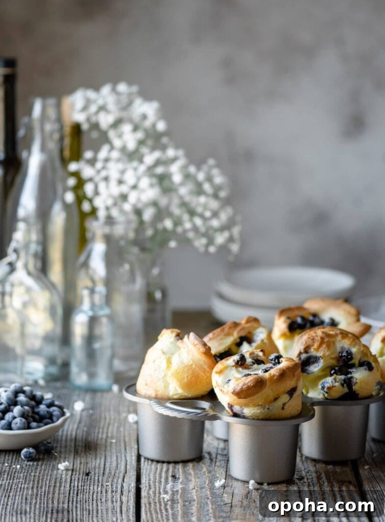 Fluffy Blueberry Popovers: Light, Crispy Breakfast Treat 3 Blueberry Popovers in a popover tin.