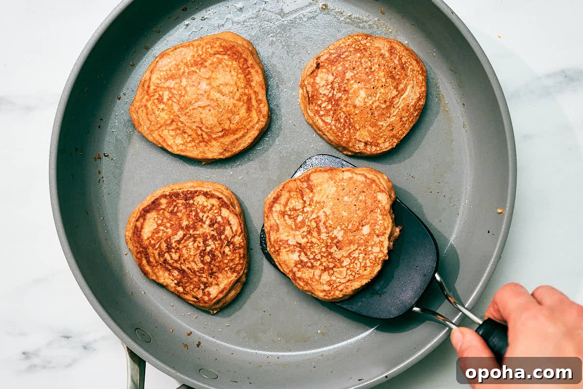 High-Protein Cottage Cheese Pancakes for Muscle Gain and Weight Loss 10 High protein cottage cheese pancakes being cooked in a skillet.