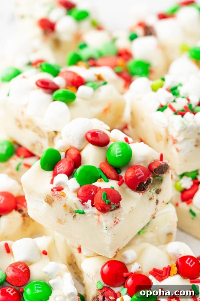 white rocky road fudge with holiday candies and marshmallows