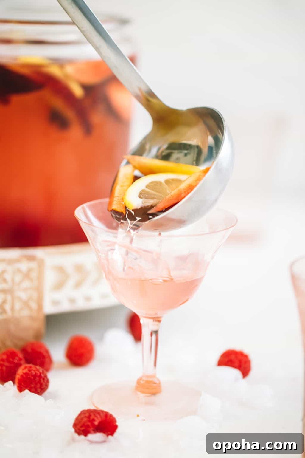 Ladle full of sangria being poured into a wine glass.