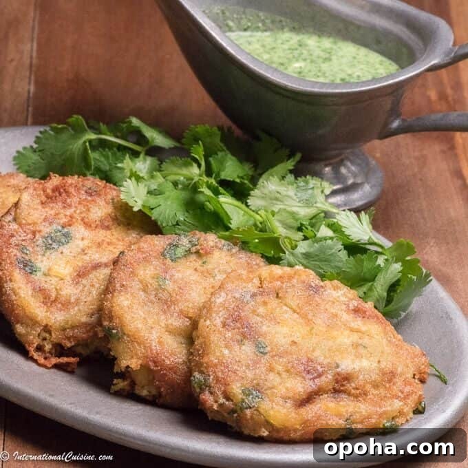 4 Pakistani Shami kebabs alongside green chutney dipping sauce