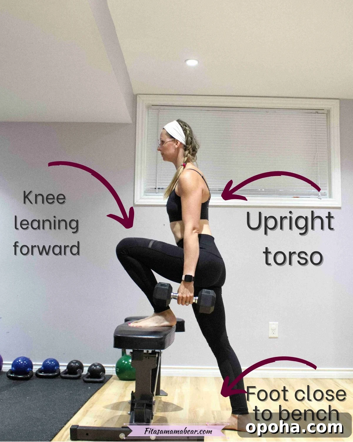 Woman in black pants and sports bra holding a dumbbell at her waist with one leg up on a bench about to do a step up