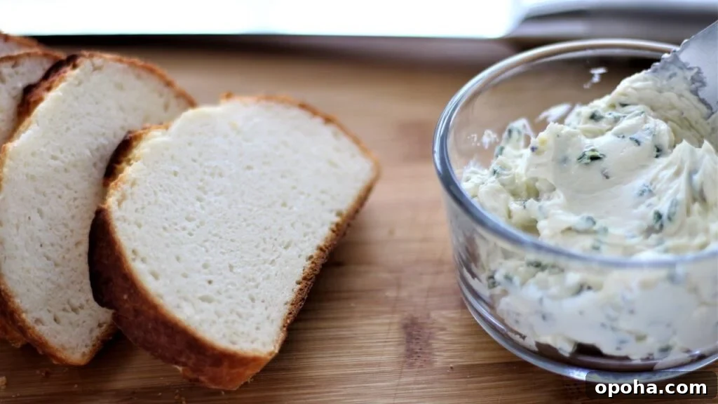 chive butter spread on cutting board with sliced bread
