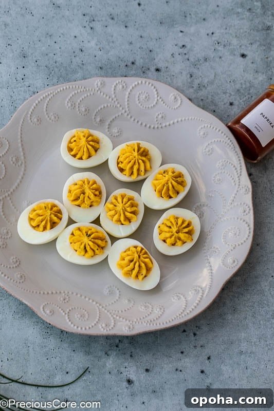 Classic Southern Deviled Eggs Recipe with Tangy Mustard-Fill 11 Southern deviled eggs on a platter.