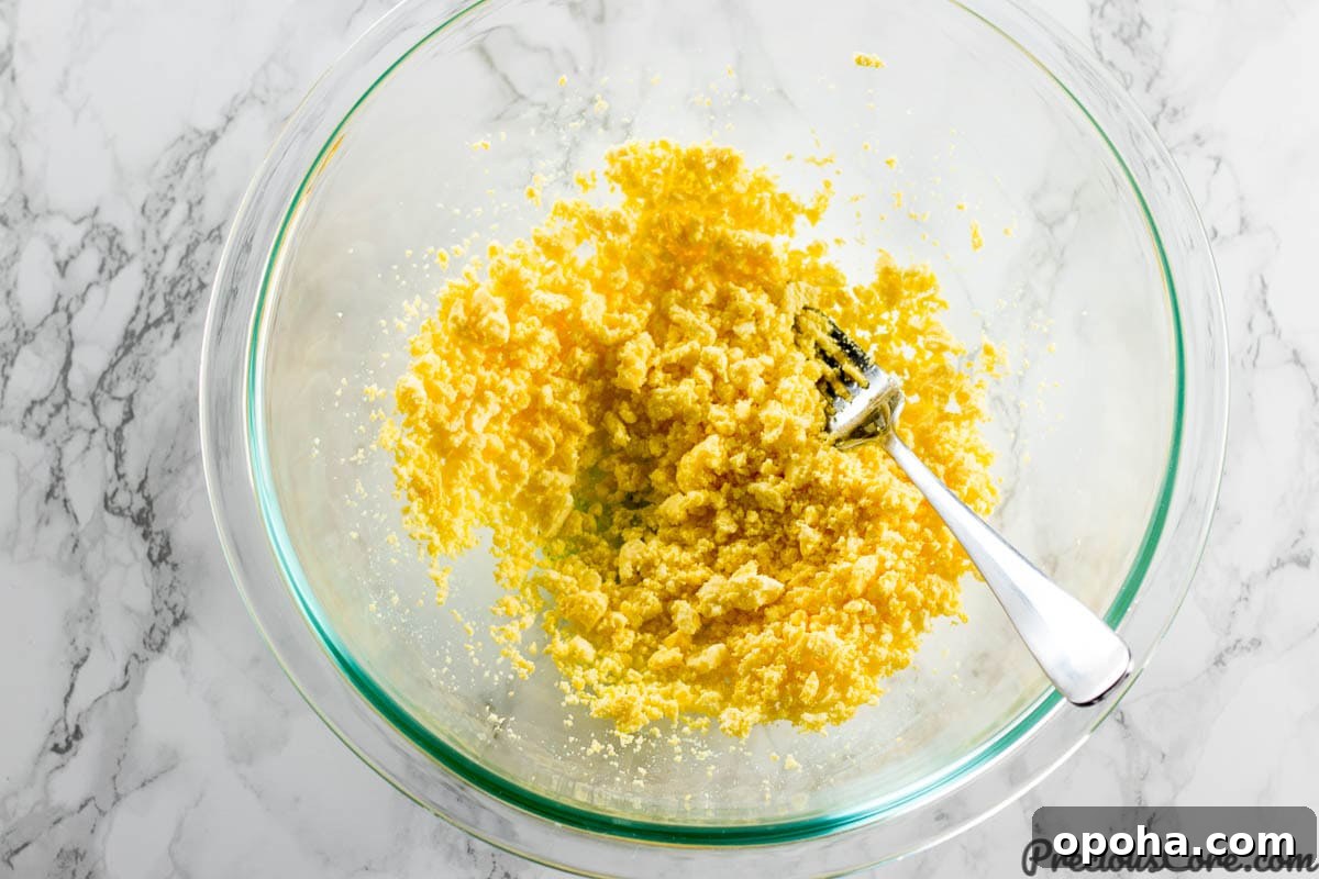 Classic Southern Deviled Eggs Recipe with Tangy Mustard-Fill 7 Mashing egg yolks for deviled eggs