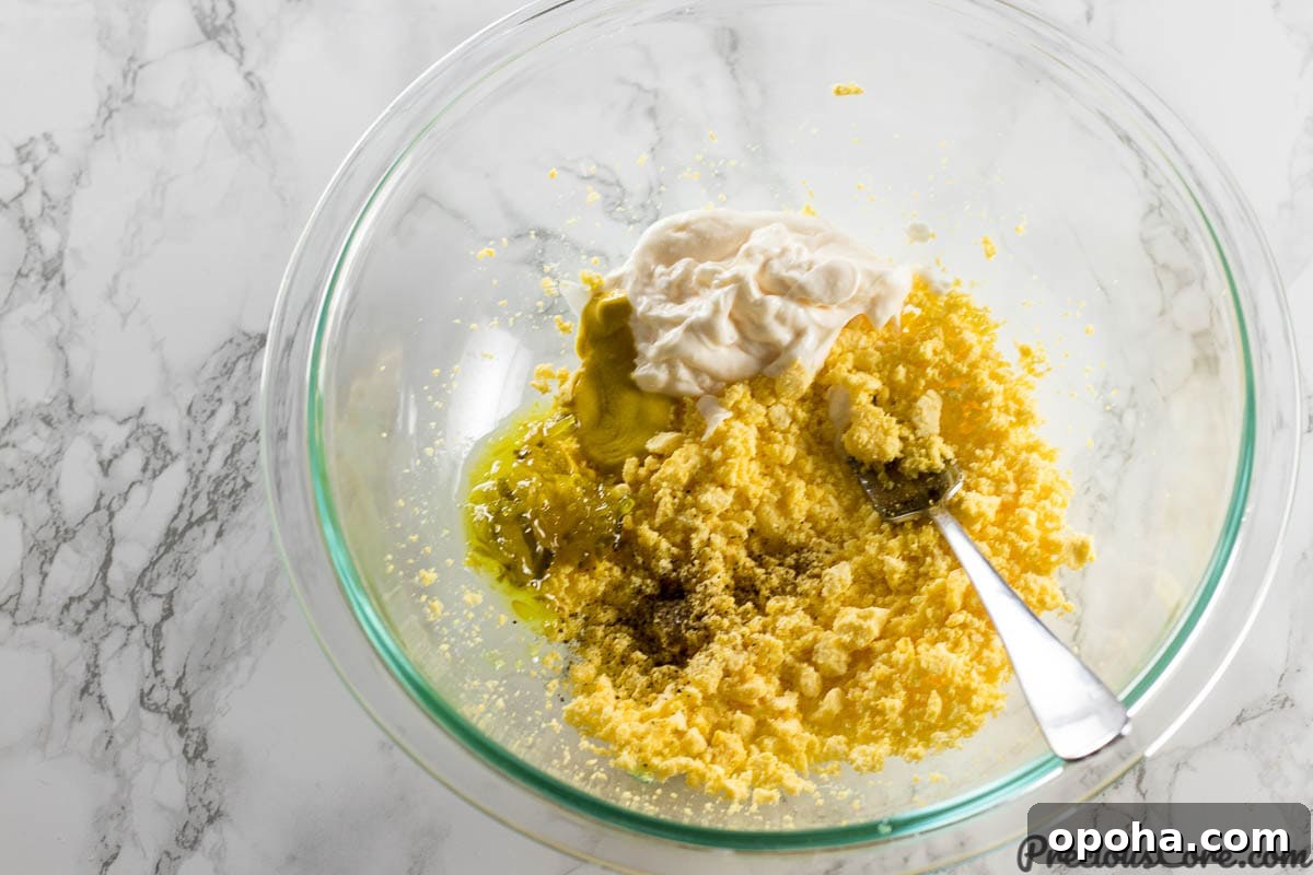Classic Southern Deviled Eggs Recipe with Tangy Mustard-Fill 8 Deviled Eggs filling ingredients in a bowl