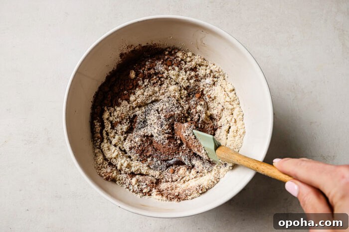 Rich pecan pie brownie batter in a white mixing bowl.