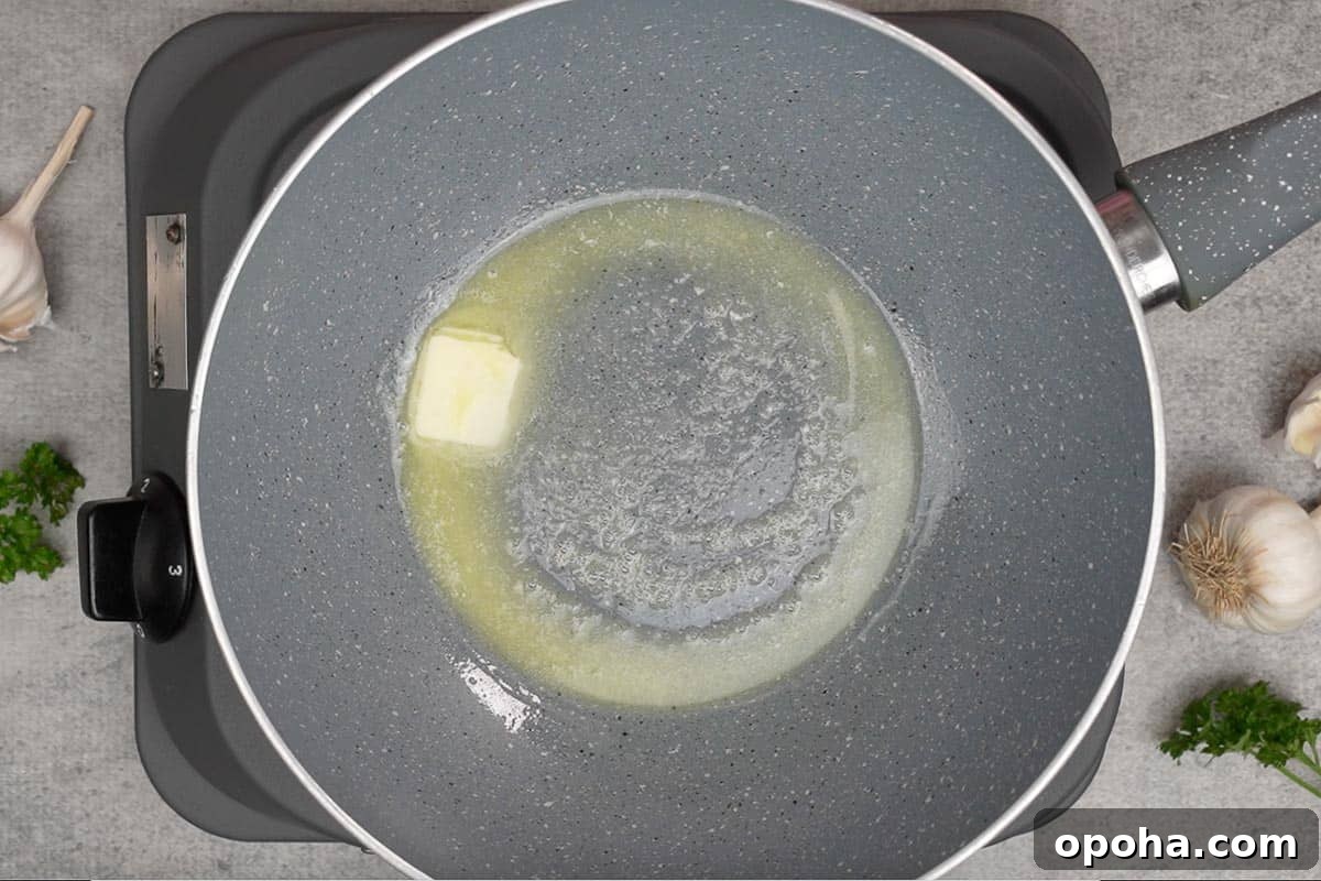 1-inch cube of butter added to a pan.