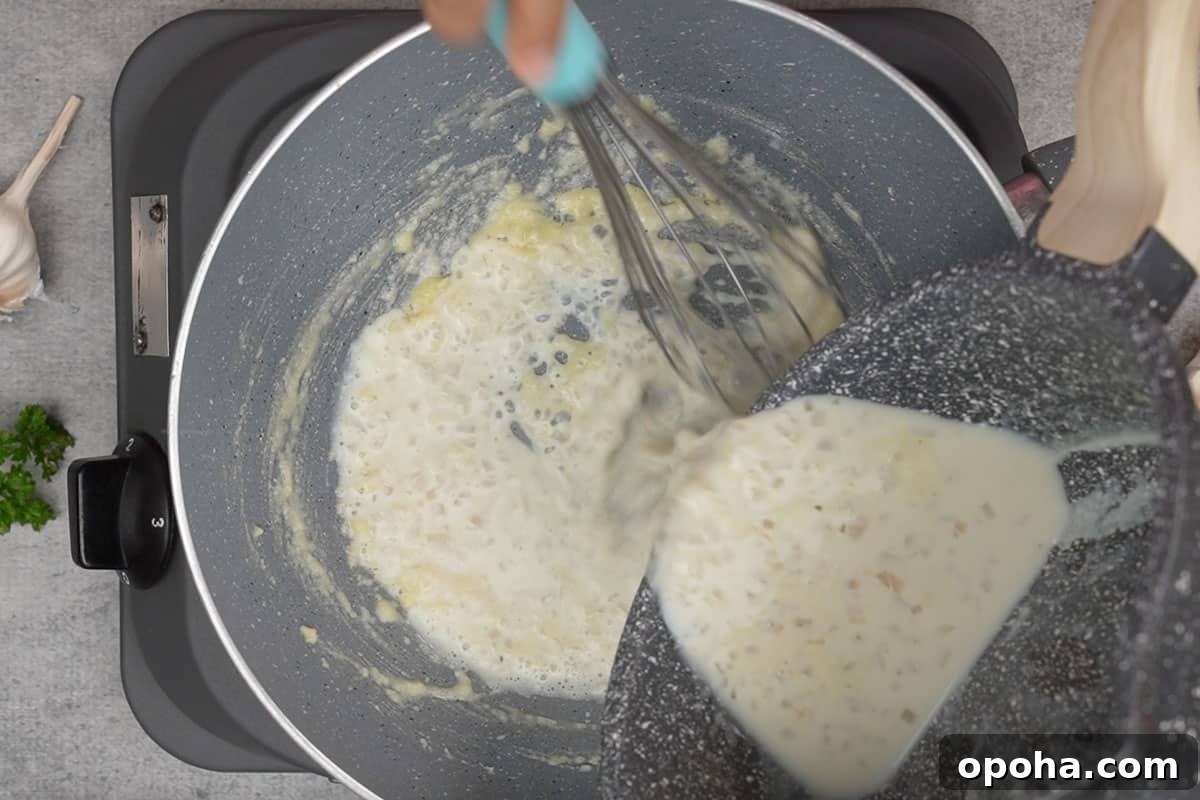 Chicken broth mixture poured in the pan with the roux.