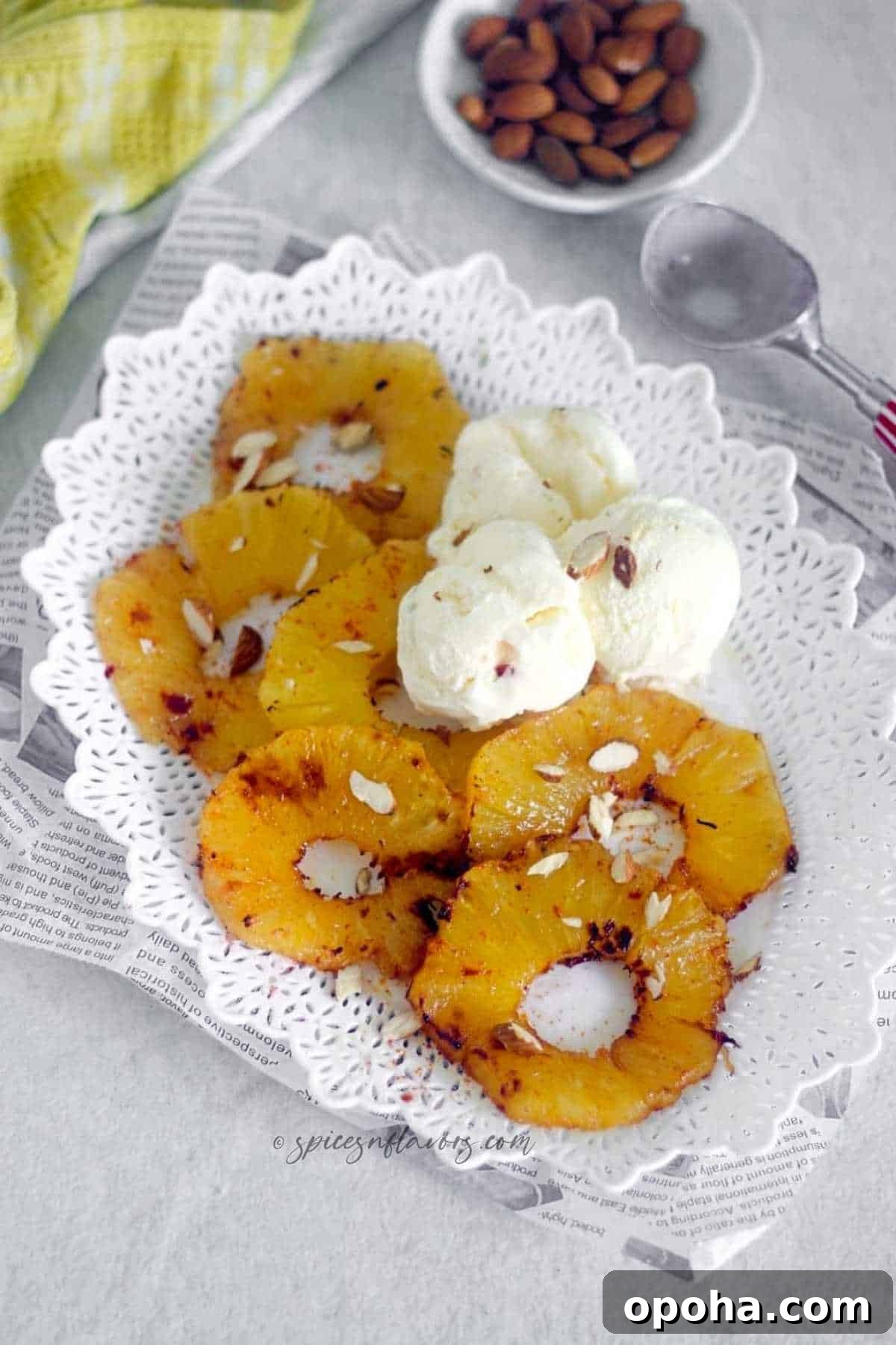 Air Fryer Cinnamon Pineapple Recipe — Grilled Flavor in Minutes 2 grilled pineapple placed on a white plate with ice cream on the side