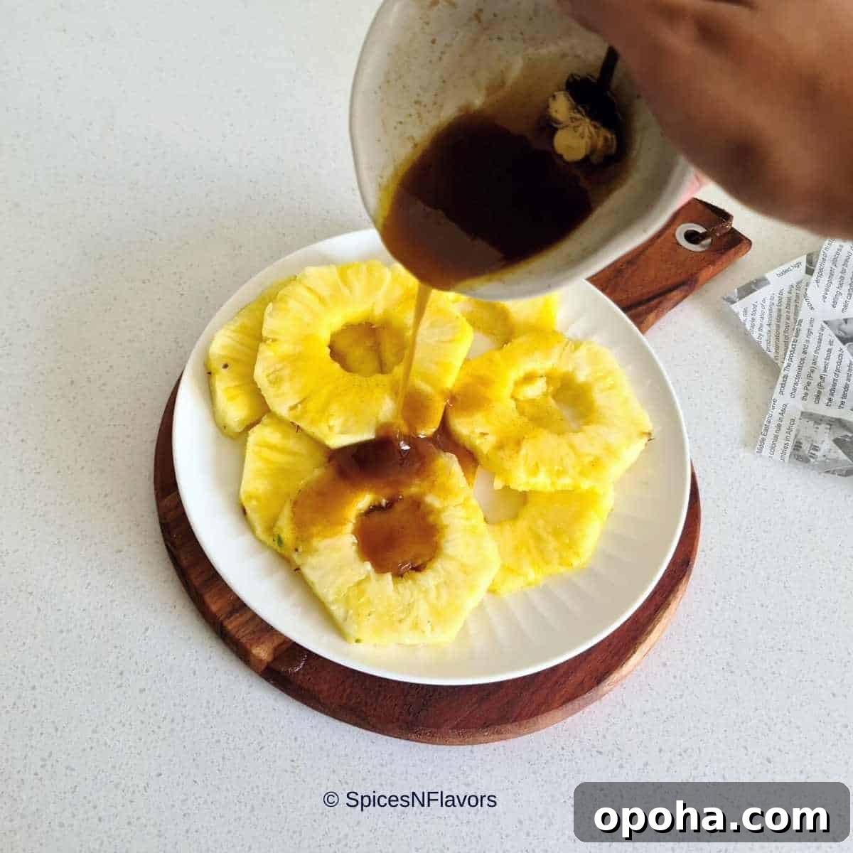 Air Fryer Cinnamon Pineapple Recipe — Grilled Flavor in Minutes 6 pouring the cinnamon butter mixture on top of the pineapple rings
