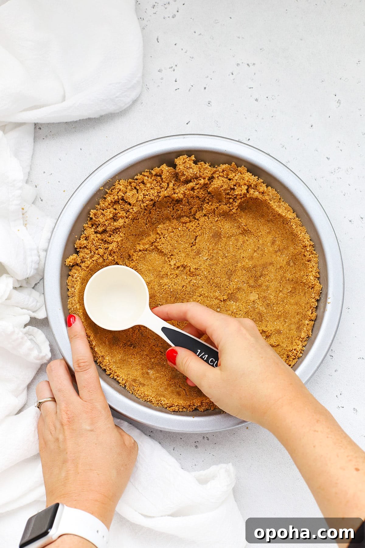 Gluten-Free Banana Cream Pie Recipe — Light, Silky & Delicious 5 Patting out a gluten-free graham cracker crust into a metal pie pan