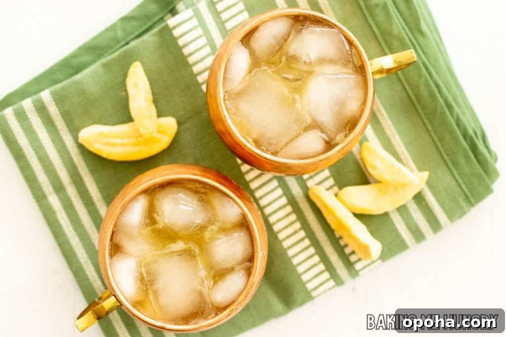 Mango Mule Mocktail Recipe: Refreshing Non-Alcoholic Cocktail 7 mango moscow mule mocktail in two copper mugs from overhead on green towel