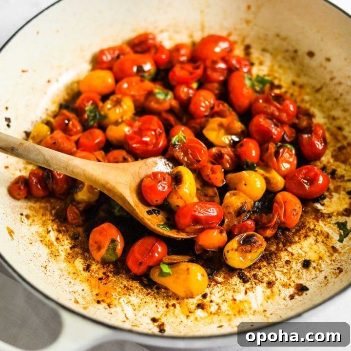 Blistered Cherry Tomatoes with olive wood spoon and Le Creuset White Braiser.