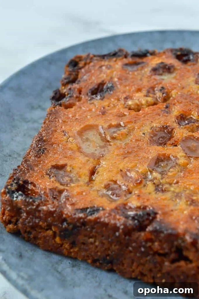 Traditional Irish Barmbrack Recipe for Perfect Fruit Tea Bread 3 Toasted buttered raisin bread on a grey plate