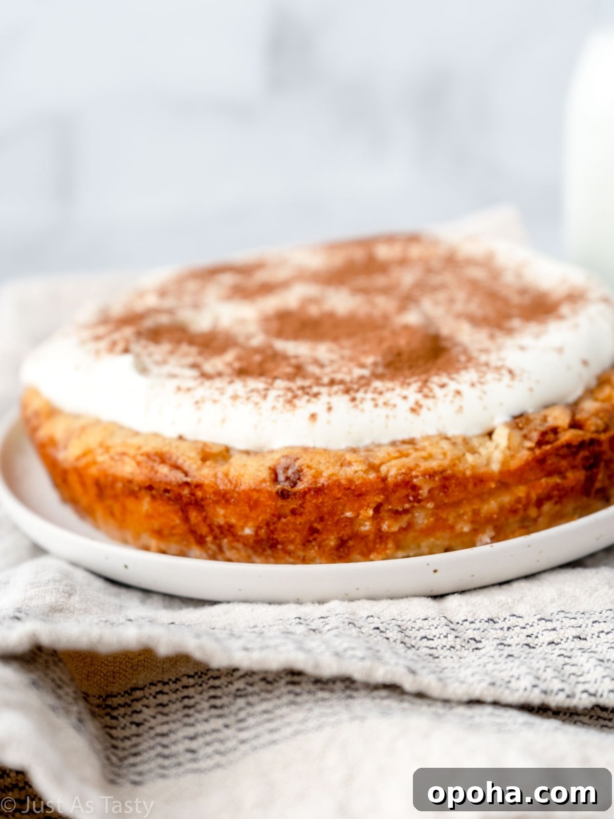 Gluten free tres leches cake on a white plate. 