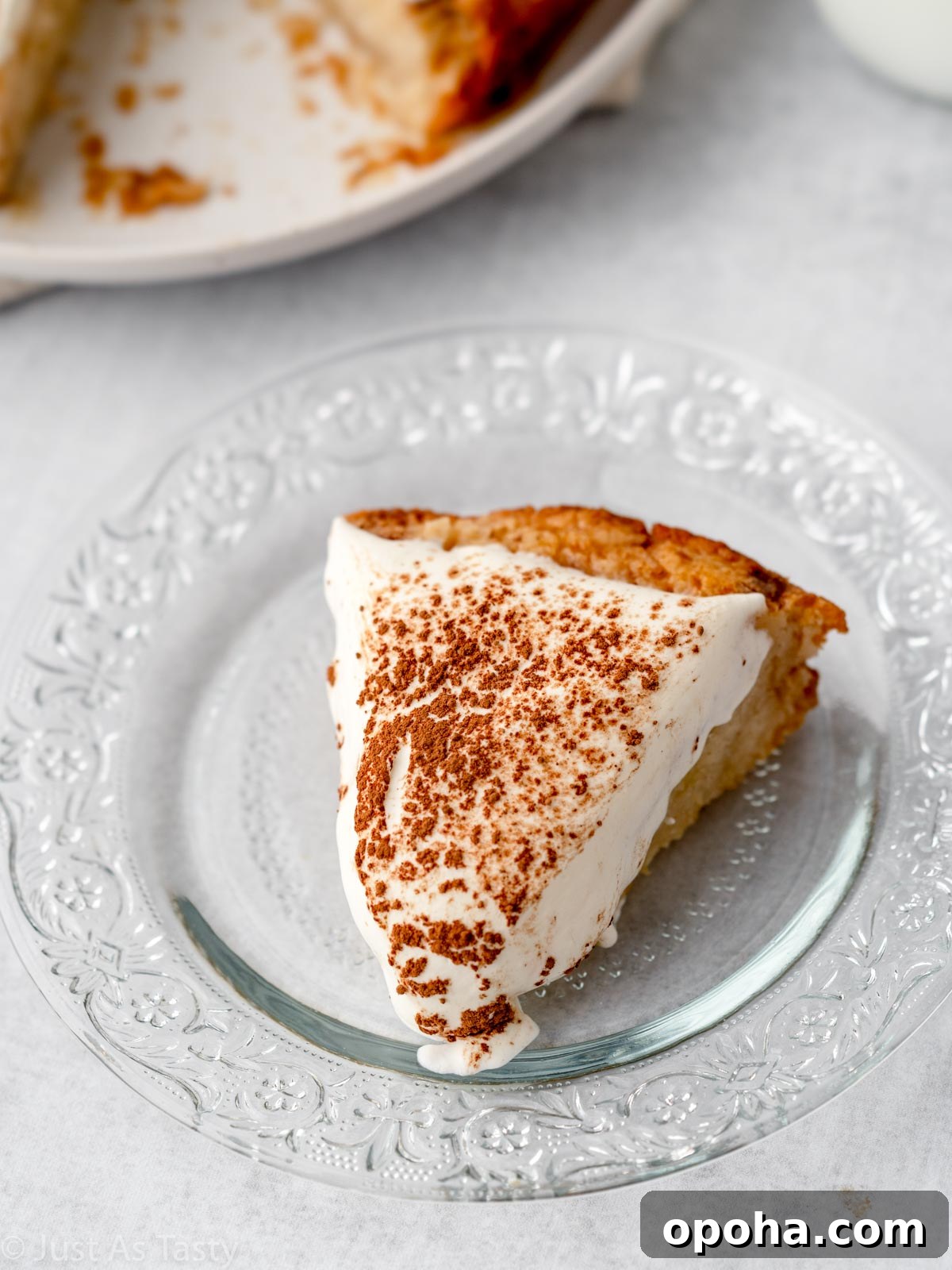Slice of gluten free tres leches cake on a glass plate. 
