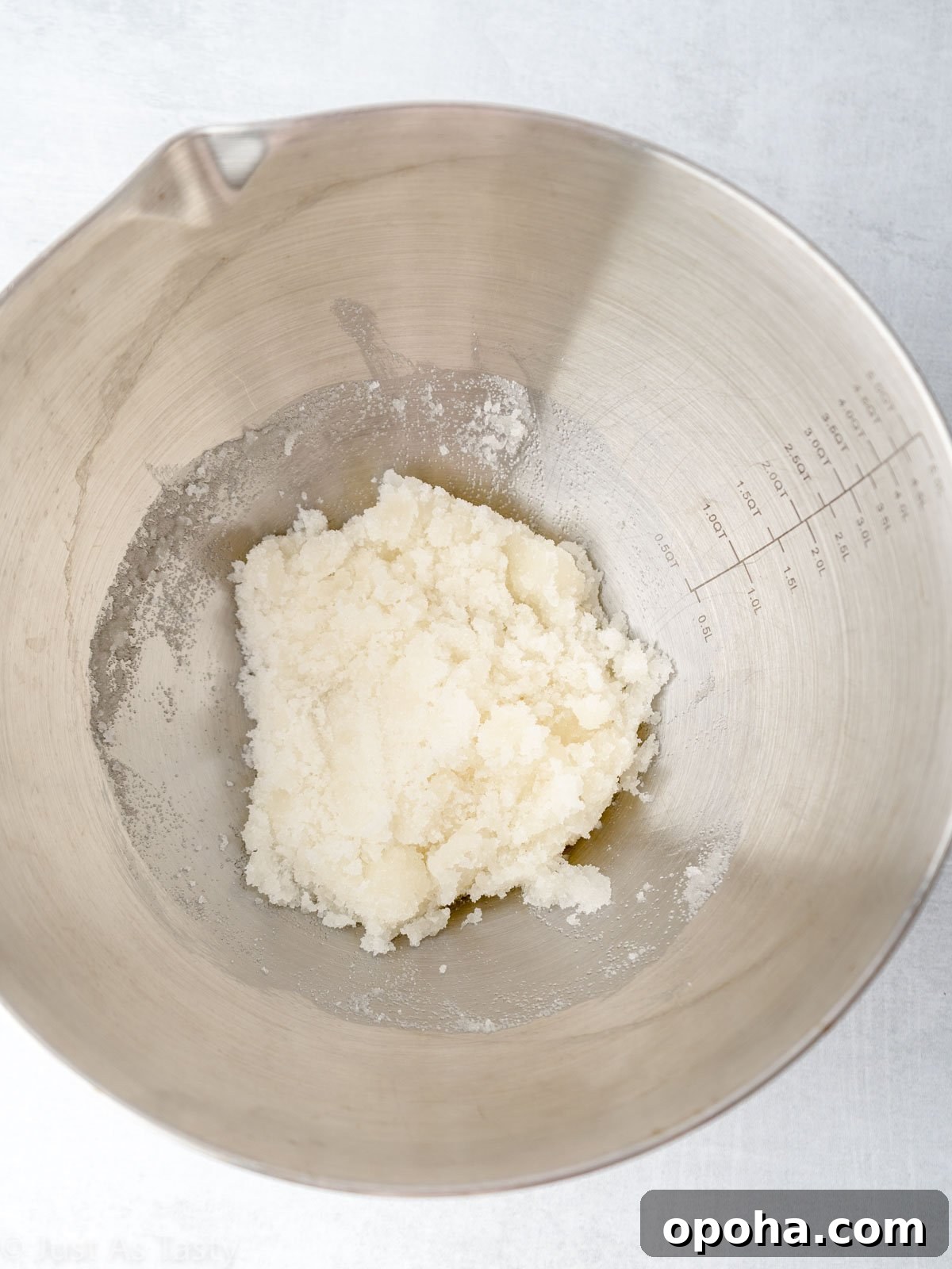 Sugar and oil combined in a mixing bowl.