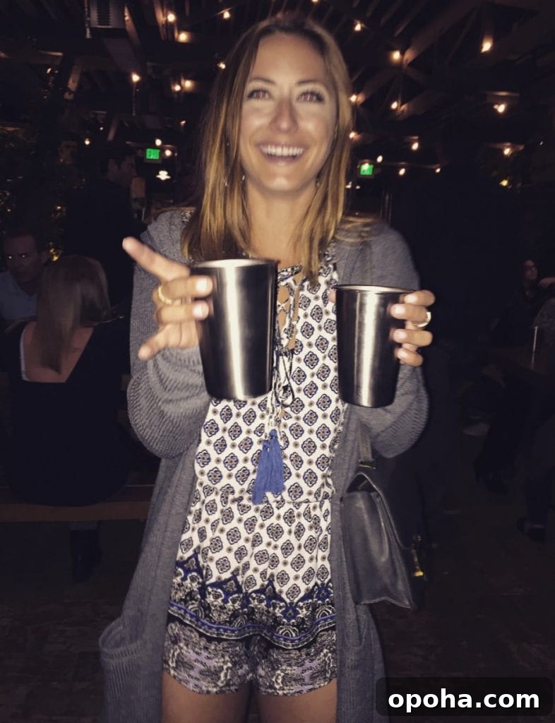 a woman holding two drinks