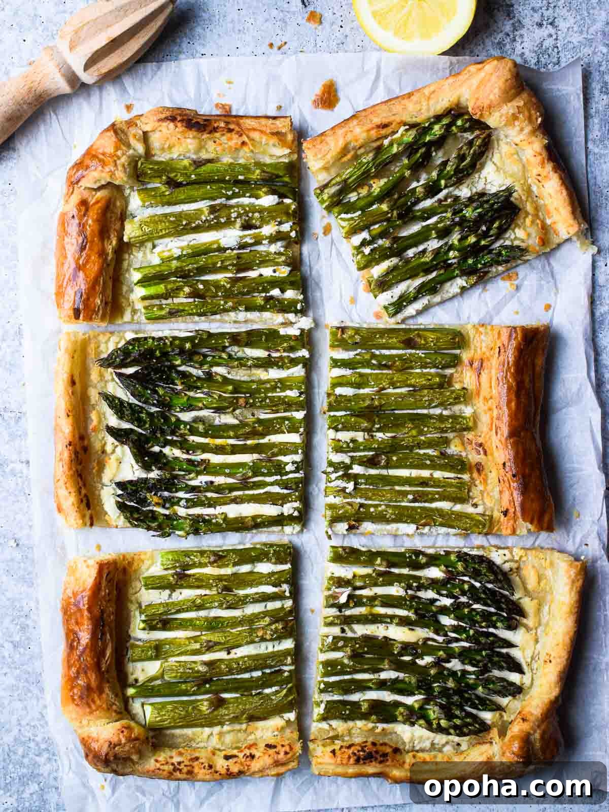 Asparagus Puff Pastry Tart with Whipped Goat Cheese Recipe 2 Overhead of asparagus and whipped goat cheese puff pastry tart cut into six pieces with a lemon to the side