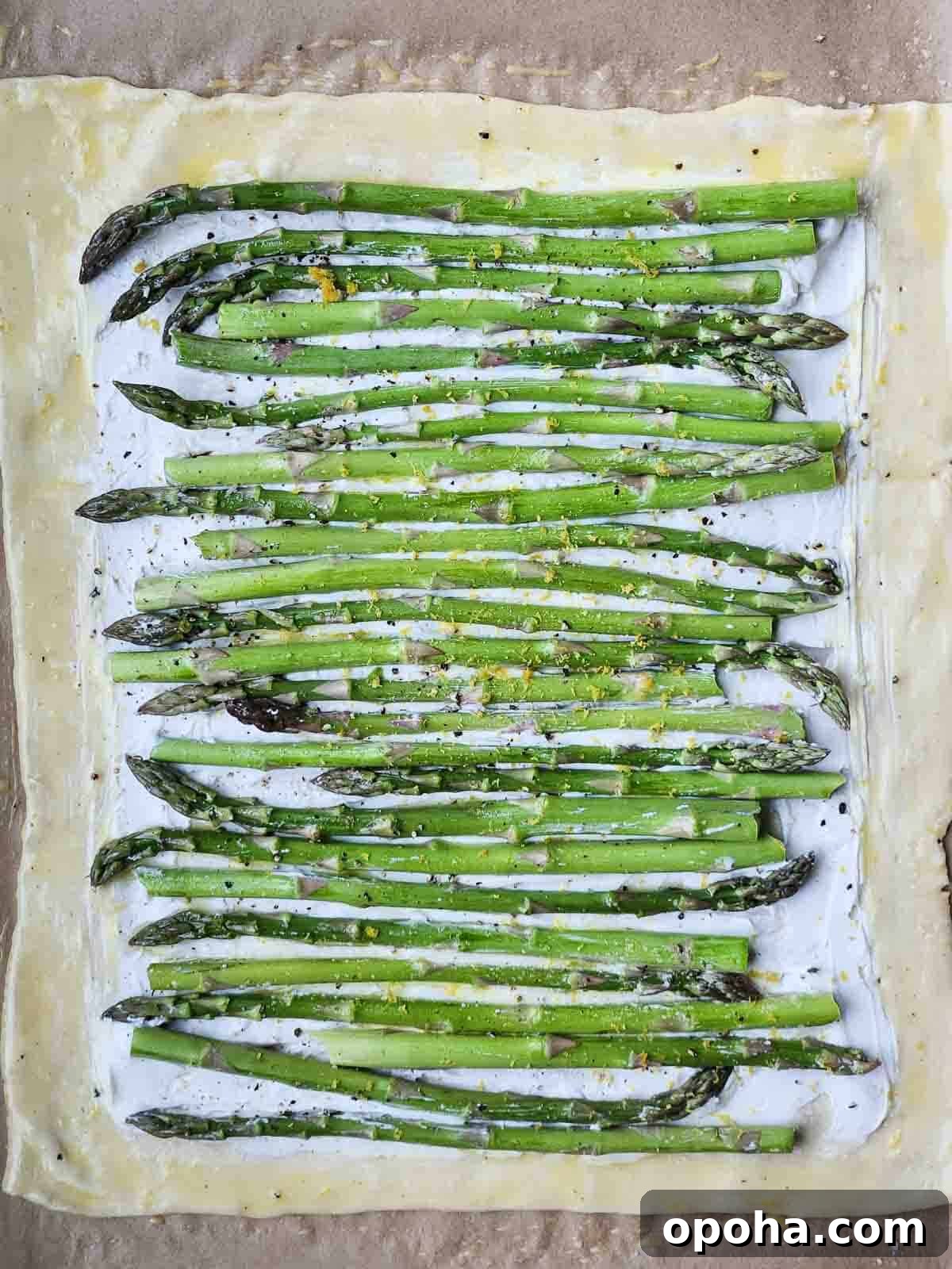 Asparagus Puff Pastry Tart with Whipped Goat Cheese Recipe 3 Uncooked puff pastry with goat cheese and asparagus on top.
