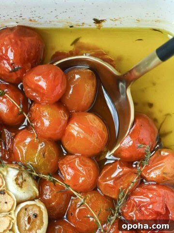 Overhead of cherry tomato confit in a baking dish.