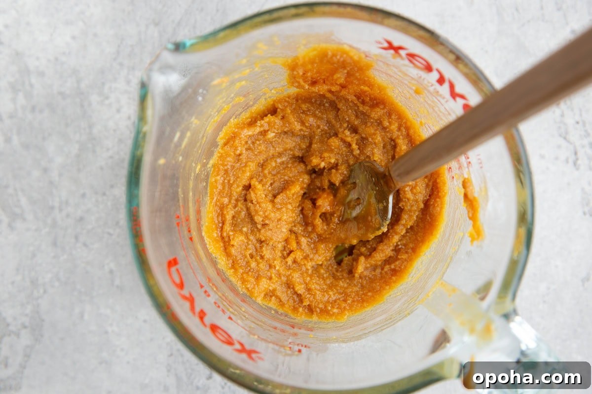 Peanut butter cake batter in a measuring cup.