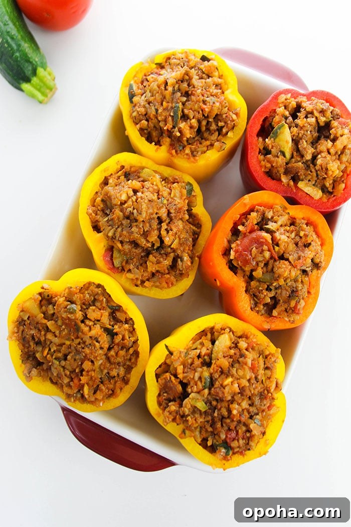 Stuffed Peppers With Rice and Ground Beef in White Casserole Dish