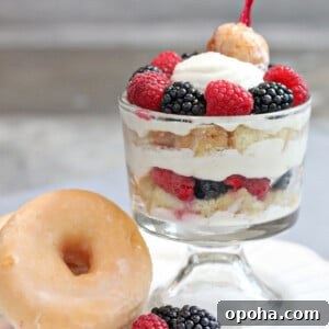 Close up of a Doughnut Trifle next to a large glazed doughnut.