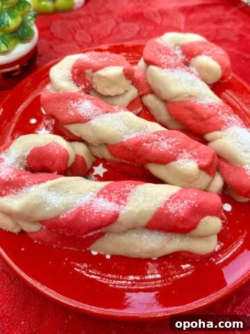 Christmas candy cane cookies stacked on a plate.