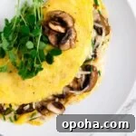 a top down view of a mushroom omelette topped with micro greens.