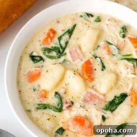 Creamy Chicken Gnocchi Soup is rich and full of Italian flavor! It is easy to make and goes well with crusty bread. simplyhappyfoodie.com #chickengnocchisoup #gnocchi #gnocchisoup
