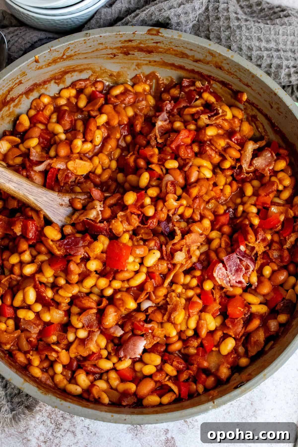 An overhead image of cooked baked beans, ready to be served.
