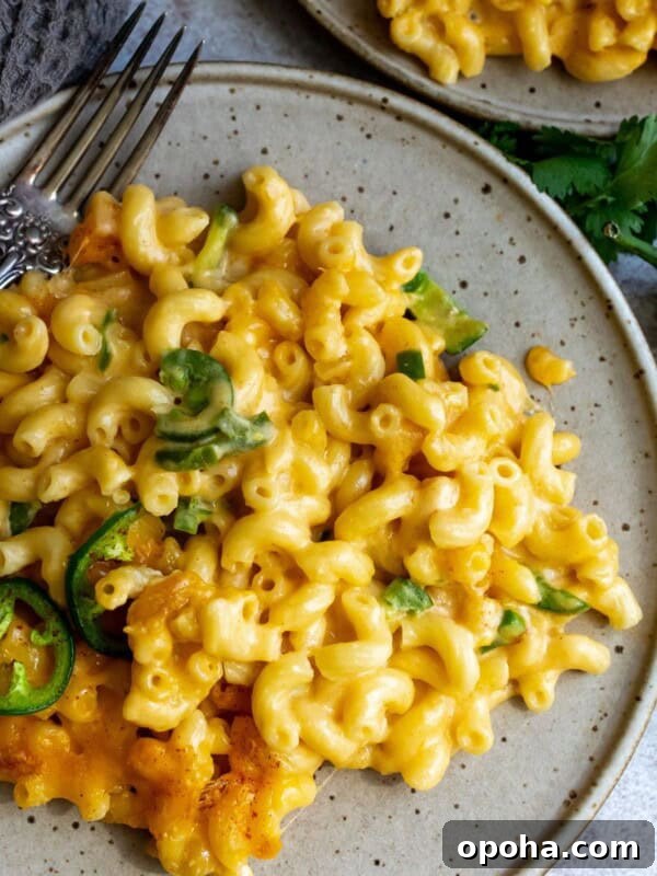 Cheesy noodles on a plate with a silver fork