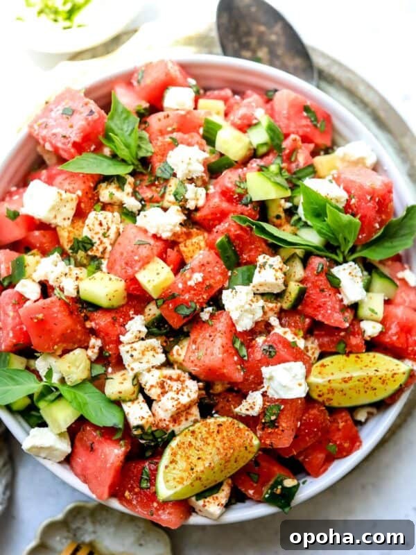 White bowl with ingredients mixed together to make watermelon salad with feta.