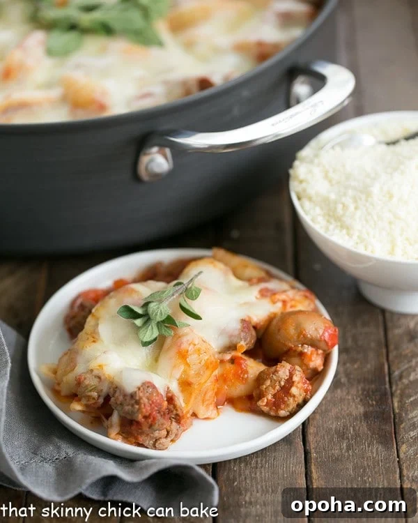 white dinner plate of Cavatini Supreme with the casserole pan full of it behind the plate
