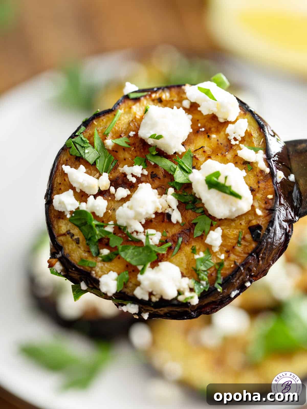 Grilled eggplant with feta cheese on a fork.