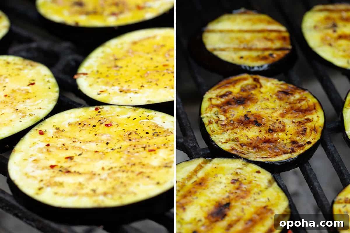 Eggplant brushed with seasoned olive oil on a grill.
