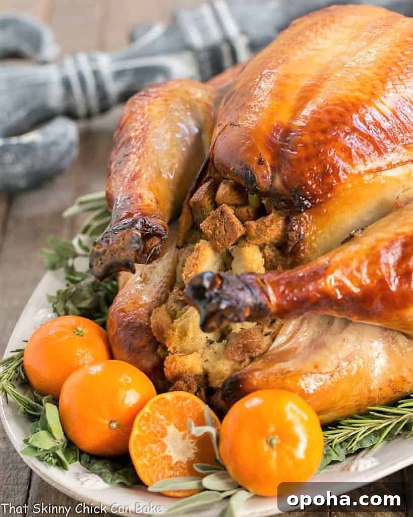 Honey Brined Turkey Recipe - The perfect way to get succulent meat from your holiday turkey Honey Brined Turkey on a white serving platter.