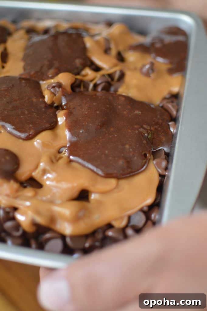 Top brownie batter dolloped over caramel layer